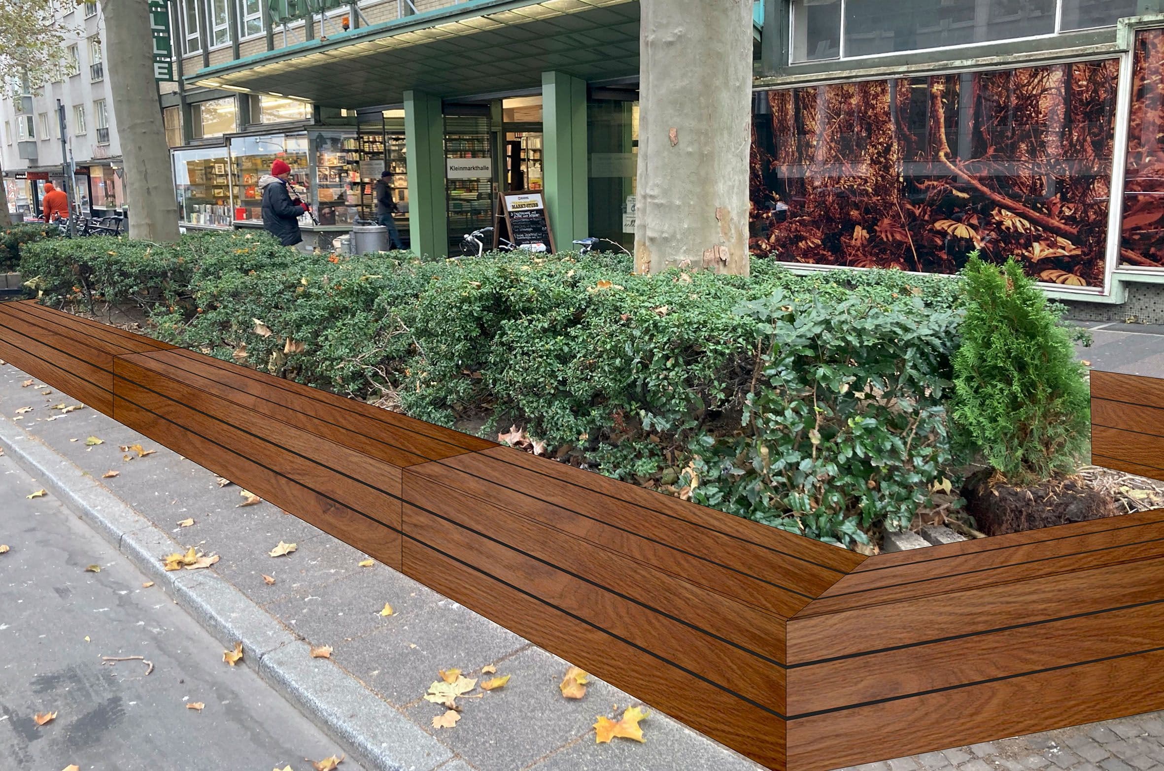 Vor einem Gebäude steht ein großer, begrünter Holzkasten.