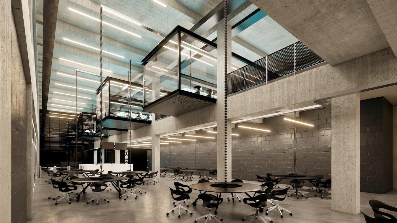 Ein großer, moderner Raum mit Tischen und Büromöbeln.