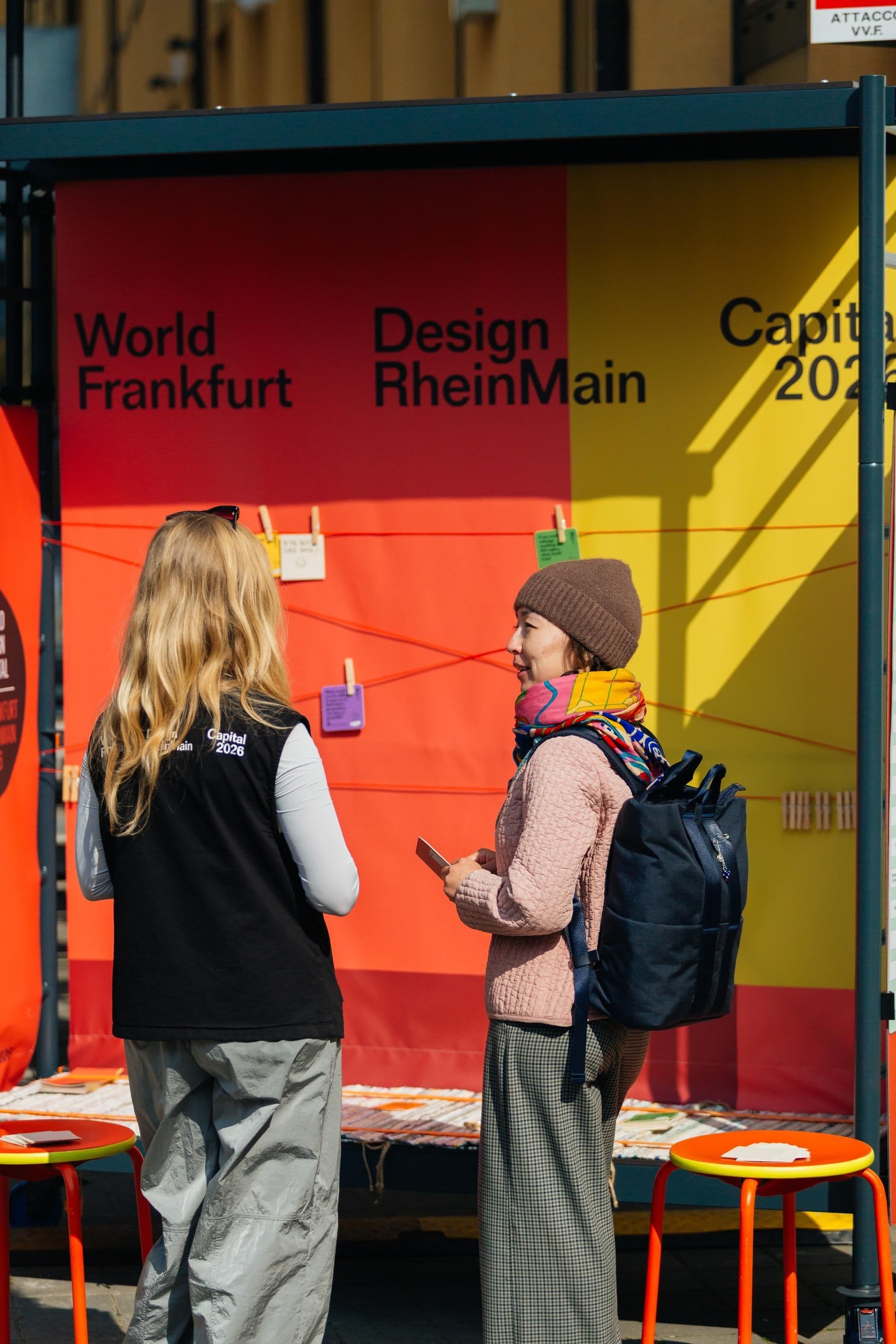 Zwei Personen stehen vor der Ausstellung des Werkstattwagens und unterhalten sich.